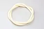 A coiled length of off-white silicone muffler pressure tubing for RC engines on a plain light grey background.