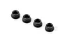 Four small black composite arm bushings for RC cars arranged in a diagonal line against a white background.