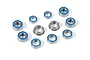 A collection of various sized metal ball bearings with blue rubber seals arranged on a white background.