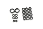 A collection of various sized rubber shielded ball bearings for RC cars arranged on a white background.