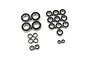 A collection of various sized rubber shielded ball bearings for RC cars arranged on a white background.