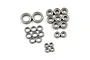 A collection of various sized metal shielded ball bearings arranged on a white background.