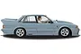 Side profile of a light blue Scalextric 1/32 scale Holden VL Commodore Group A SV slot car on a white background.