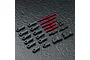 A set of red anodized aluminium turnbuckles, black plastic rod ends, and small black metal screws arranged on a textured dark grey surface.