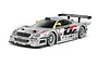 A studio shot of a 1/10 scale Tamiya Mercedes-Benz CLK-GTR RC car in silver with Warsteiner racing livery, shown from a front three-quarter angle.