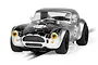 Scalextric 1/32 scale Shelby Cobra 289 Snake Eyes slot car in silver and black with number 94 on the hood and doors.