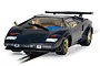 A 1/32 scale Scalextric Lamborghini Countach slot car in dark blue with gold wheels, positioned on a slot car track.