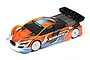 A 1/10 scale XRAY X4 touring car RC model with a custom orange, blue, and white painted body shell and a black rear wing.