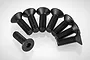A set of eight black metal countersunk hex head screws arranged in a semi-circle on a white background.