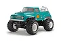Tamiya GF-02 Squash Van RC monster truck kit, featuring a teal and white body with pumpkin graphics, large black off-road tires, and white wheels.