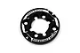 A black circular aluminium motor mount conversion plate by Yeah Racing with white engraved text on a white background.