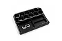 A black aluminum Yeah Racing tools and parts stand with multiple circular holes for tools, storage compartments, and a built-in ruler.