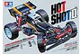 Tamiya Hotshot II (2024) 1/10 scale 4WD RC buggy kit box art showing the black and orange off-road vehicle with red shock absorbers.