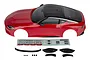 Team Associated 1/10 scale Nissan Z painted body shell in passion red with black roof, including decal sheet and plastic trim accessories.
