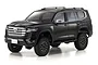 A black Kyosho Mini-Z Toyota Landcruiser 4x4 RC rock crawler model viewed from a front three-quarter angle against a white background.