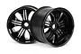Two black HPI Savage Tremor RC monster truck rims shown from a front-facing angle against a white background.