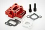 A red anodized aluminium air intake manifold with heat sink fins, two black bolts, and two gaskets on a white background.