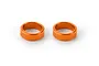 Two orange anodized aluminium steering arm shims for RC cars, shown against a plain white background.