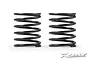 Two black XRAY ULP 4S 20mm shock springs standing side by side against a white background.