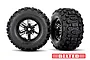 Two Traxxas Sledgehammer belted RC monster truck tires mounted on black chrome wheels, isolated on a white background.