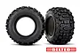 Two Traxxas Sledgehammer belted RC tires shown from side and front angles against a white background.