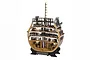 A detailed 1/72 scale wooden model cross-section of the HMS Victory ship, showing multiple interior decks with miniature crew figures and barrels.