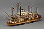 A fully assembled Artesania Latina King of the Mississippi paddle steamer wooden model kit on a display stand.