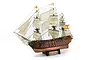 A detailed 1/84 scale wooden model of the Spanish ship Santisima Trinidad with full rigging and sails, mounted on a black display stand.