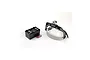 Artesania Latina hands-free magnifying headset with LED light, a storage case for interchangeable lenses, and two batteries on a white background.