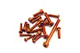 A collection of orange anodized aluminium socket head screws of various lengths scattered on a white background.