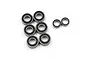 A collection of eight rubber-shielded metal ball bearings of varying sizes arranged on a white background.