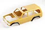 A yellow FMS Land Cruiser 80 RC car body shell with black wheel arches, viewed from a high angle against a white background.