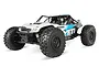 Axial Yeti 1/10 scale RC rock racer truck in white and black with blue graphics, featuring large off-road tires and a roll cage.