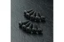 Ten black button head hex screws arranged in two rows on a textured black surface.