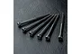 Six black metal cap head screws arranged in a fan shape on a textured black surface.
