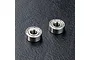 Two small metal shielded ball bearings placed on a textured black surface.