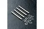 Four silver metal RC shock shafts and a collection of small metal E-clips arranged on a black textured surface.