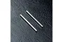 Two silver metal suspension arm pins for an RC car, shown on a textured black background.