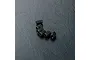 Six small black metal grub screws arranged in a slight curve on a textured black surface.