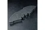 A black foam front bumper for an RC car, featuring a contoured shape with cutouts, resting on a textured black surface.