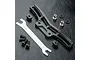 MST black aluminium front shock mount set with adjustment tool and included hardware on a black textured surface.