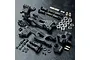 MST rear suspension arm set including plastic arms, uprights, metal shafts, bearings, and screws on a black textured surface.