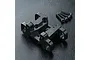 MST black aluminium upper suspension arm mount for RC cars with four included mounting screws on a textured black surface.