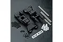 MST black aluminium rear lower suspension arm set including metal pins, screws, plastic bushings, and MST logo stickers on a black textured background.
