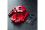 MST red aluminium gearbox housing set including two main casing halves, small screws, washers, and two MST branded stickers on a dark textured surface.