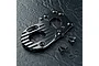 Black anodized aluminium motor mount for RC cars with cooling fins, accompanied by four small black screws and two washers on a dark textured surface.