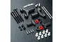 MST black aluminium front lower suspension arm set with various screws, pins, plastic spacers, and bushings on a black textured surface.