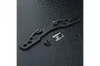 MST black lightweight aluminium bumper support for RC cars, including two screws and an MST logo sticker on a dark textured surface.