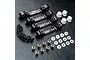 A set of four black aluminium suspension arm mounts by MST, including screws, plastic bushings, and metal ball studs on a textured black surface.