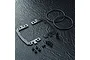 MST Carbon Fibre Battery Mount Set components including carbon plates, O-rings, screws, and spacers on a dark textured surface.